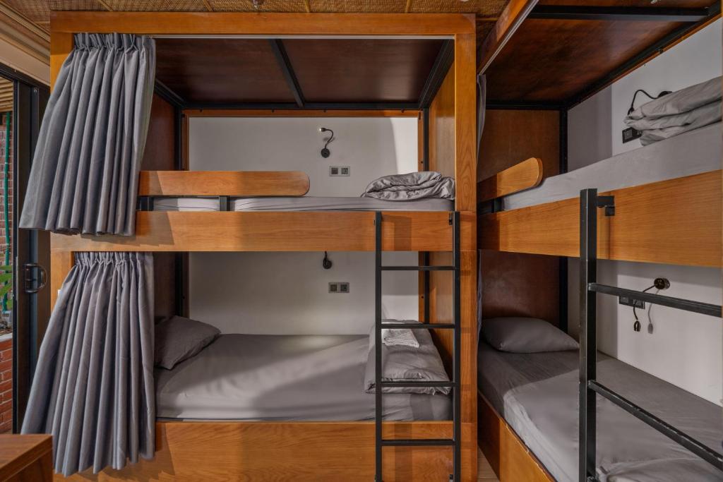 Bed in Male Dormitory Room with Curtain